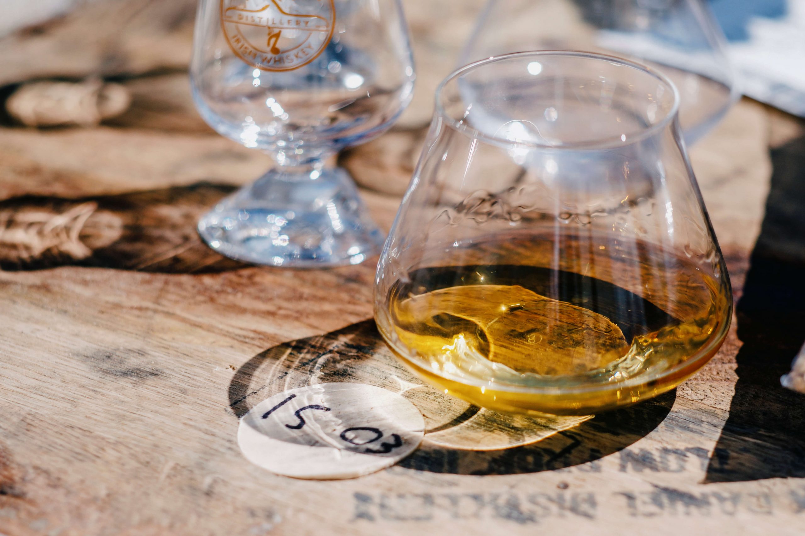 2 whiskey drams on a barrel top