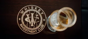 A whiskey dram beside the Whiskey Investment Club logo